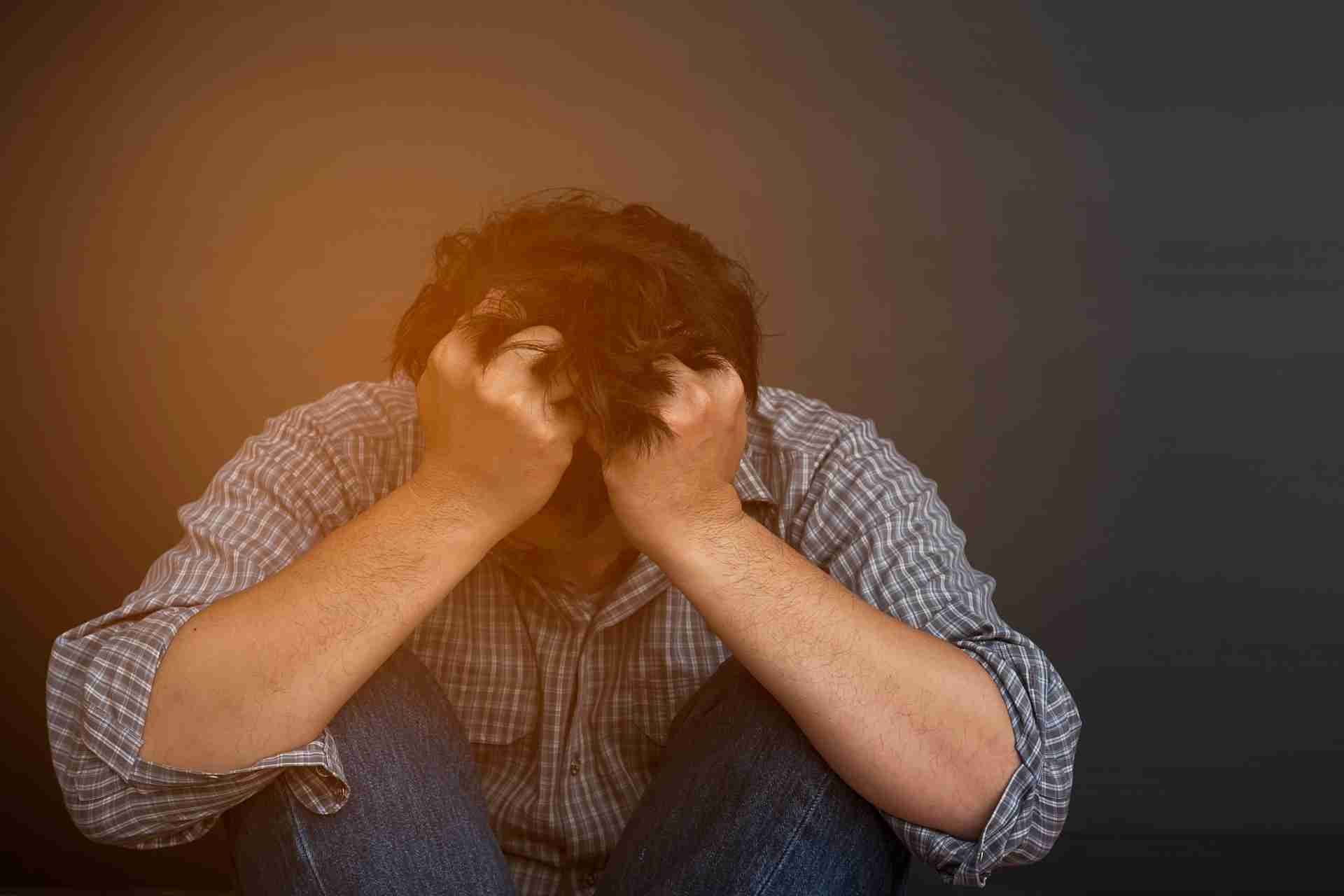 Person experiencing emotional distress and mental health challenges related to addiction