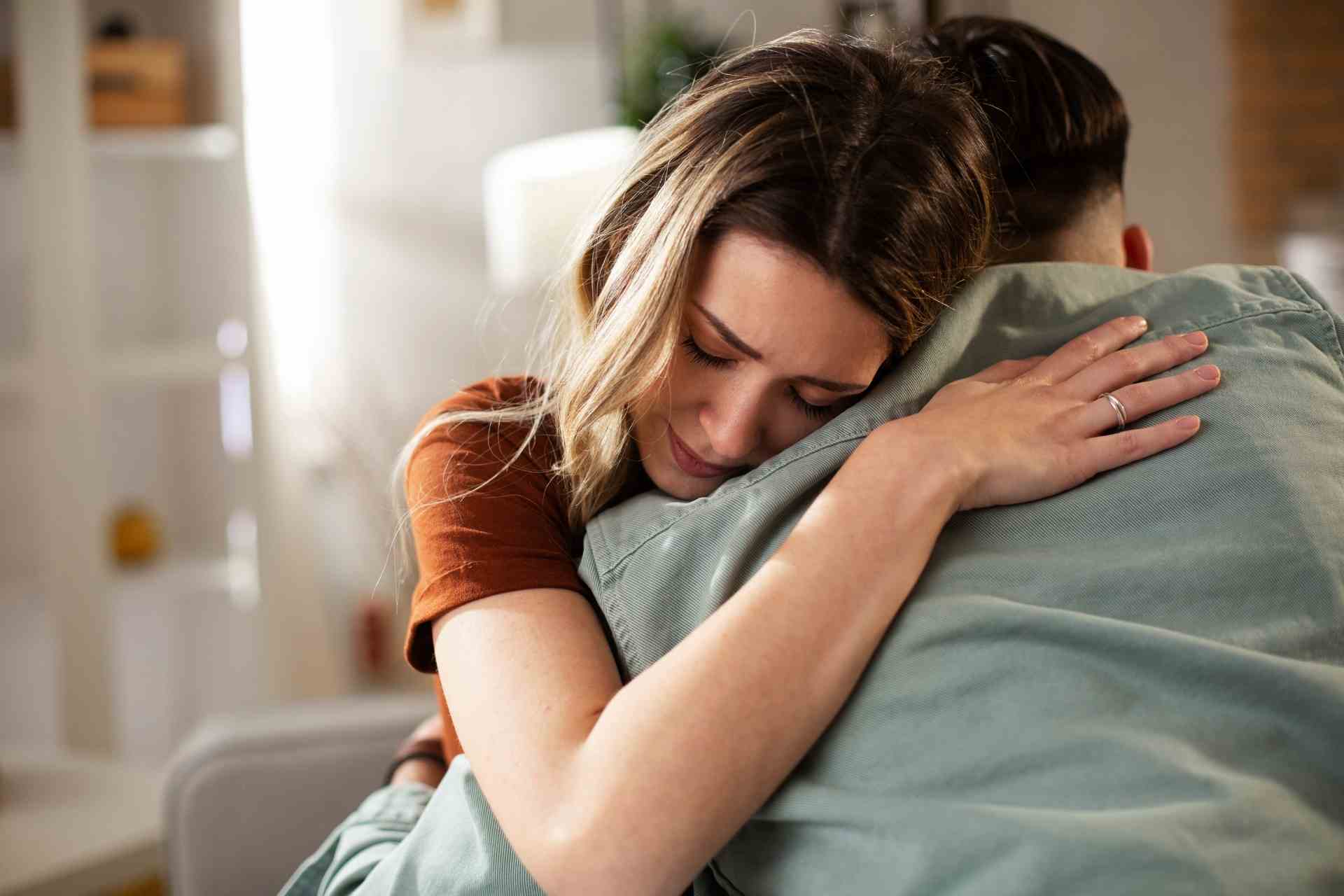 Woman hugging a man showing emotional support during addiction recovery