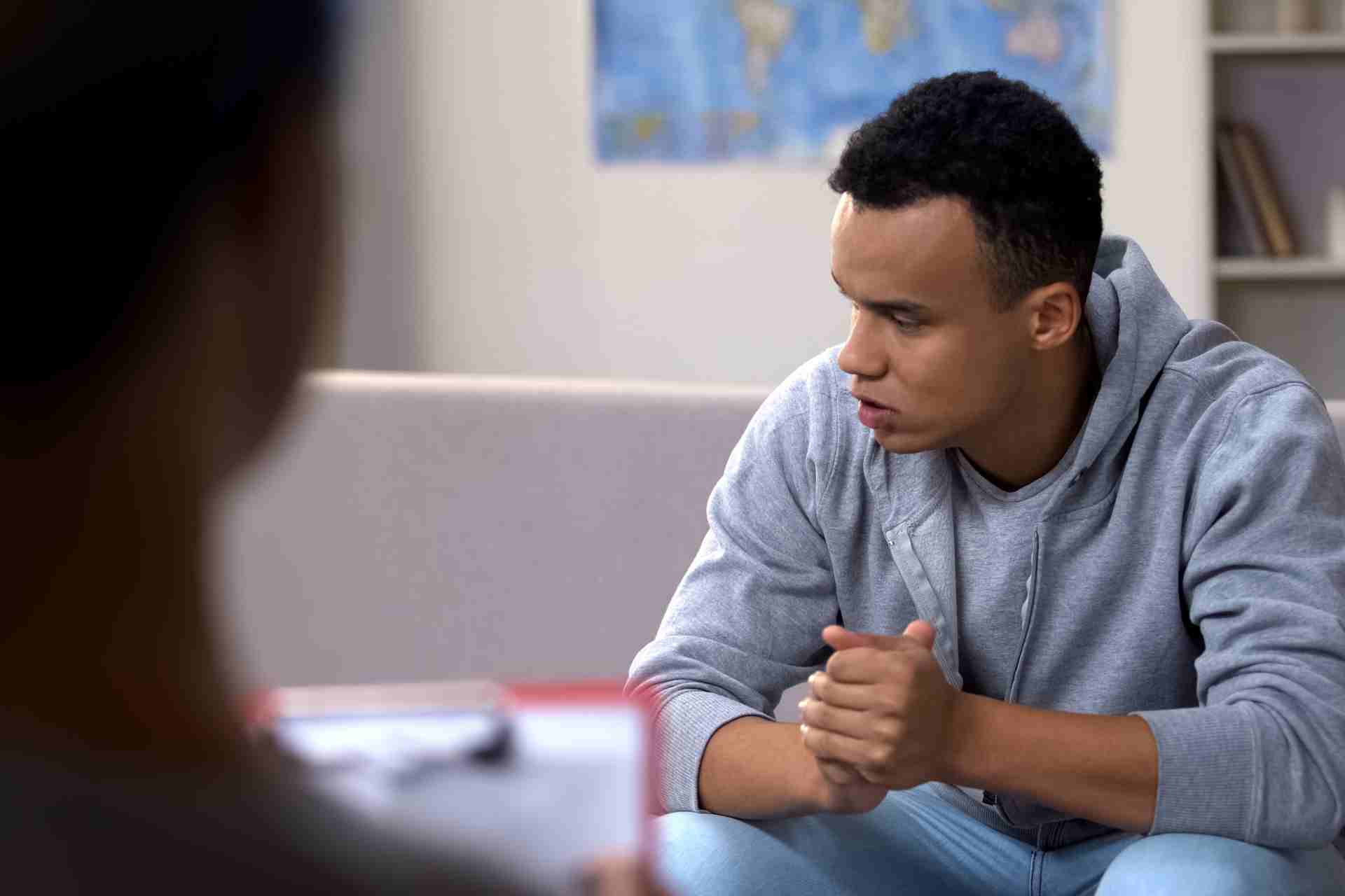 Young man speaking during an addiction treatment counseling session