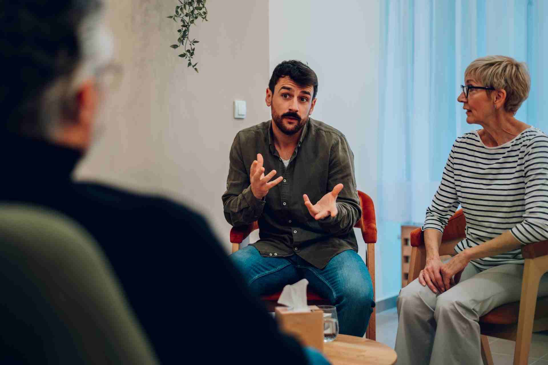 Family members and a loved one discussing addiction treatment options during a supportive intervention meeting in New Jersey.