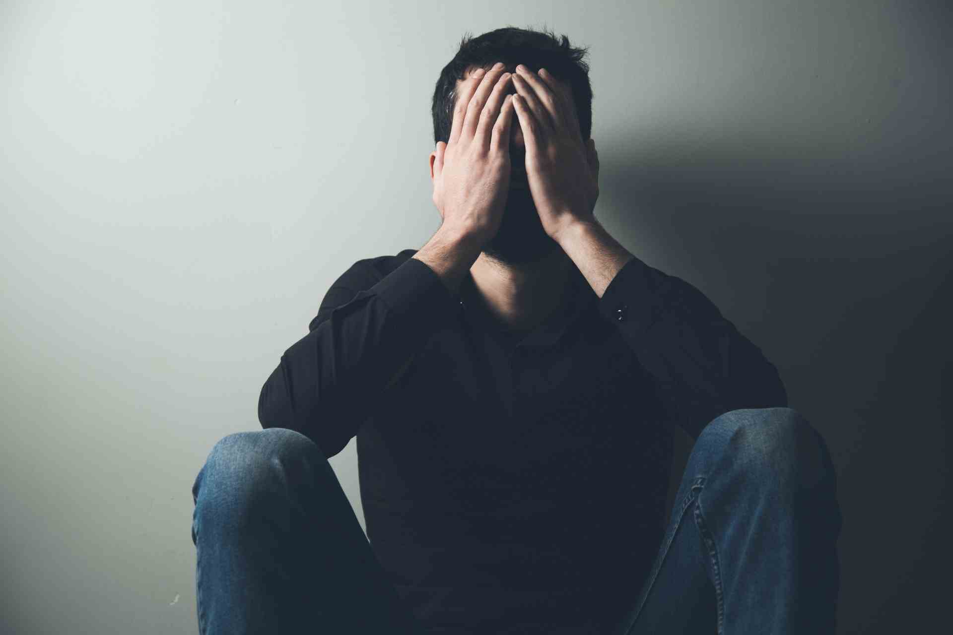 Man experiencing anxiety and emotional distress associated with meth addiction.