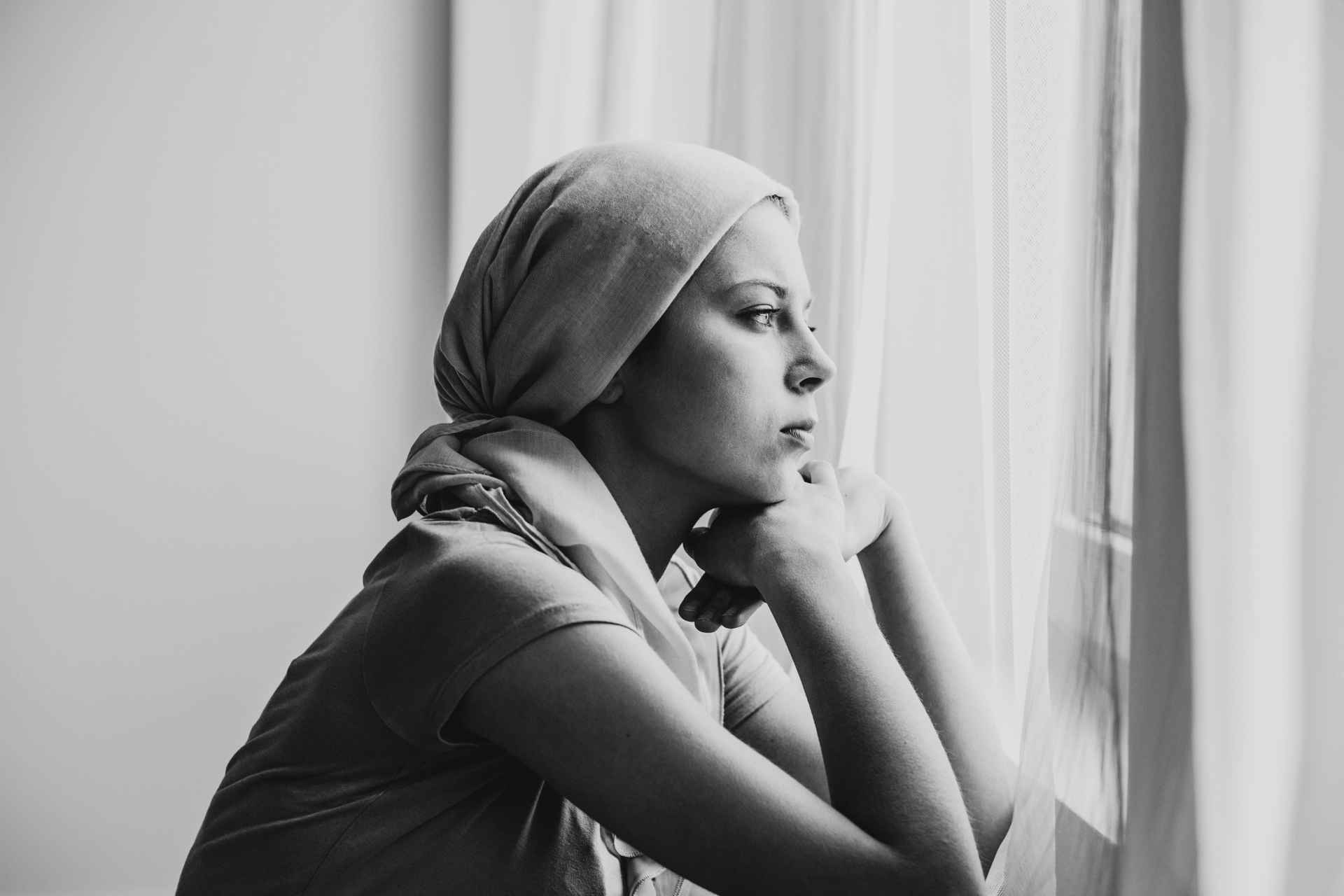 Woman reflecting by a window during early addiction recovery
